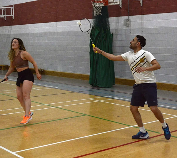 Two R.W.P badminton club members playing mixed doubles badminton